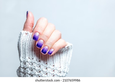 Female manicure violet gradient and glitter nails  Closeup  Concept cosmos  night neutral background 