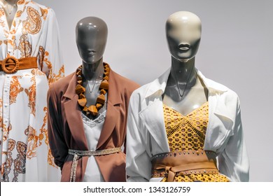 Female mannequins standing in store window display of women casual clothing shop in shopping mall