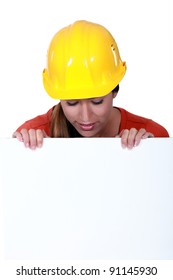 Female Manual Worker Staring At Blank Poster