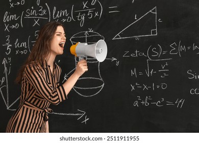 Female Math teacher shouting into megaphone near blackboard in classroom - Powered by Shutterstock