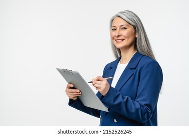 Female Mature Auditor Inspector Examiner Controller In Formal Wear Writing On Clipboard, Checking The Quality Of Goods And Service Looking At Camera Isolated In White Background