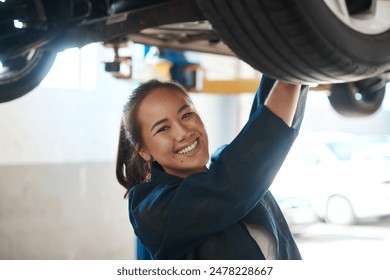 Female mechanic, check and tool for service with car in garage, inspection or maintenance on wheel. Woman, auto and happiness for problem with motor tyre, technician working or repair on transport - Powered by Shutterstock