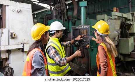 Female Mechanic Interns, Engineers Or Workers With Hardhat And Safety Gears Working With Supervisor In A Factory Checking The Function Of A System. In House Training For Factory Service Maintenance