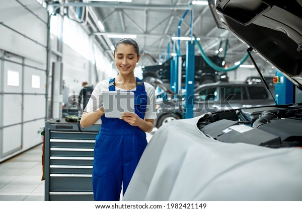 Female mechanic with\
laptop, car service