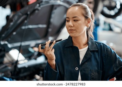 Female mechanic, smartphone and repairs in garage for internet, research and car service in workshop. Woman, reading and technology with information for ideas, maintenance and quality assurance - Powered by Shutterstock