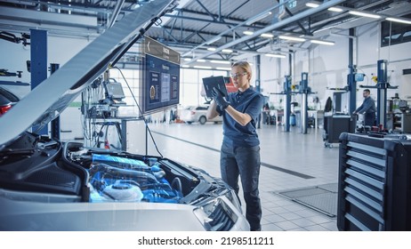 Female Mechanic Uses a Tablet Computer with an Augmented Reality Diagnostics Software. Specialist Inspecting Car's V6 Engine to Quickly Spot Broken Components. Premium Car Service. - Powered by Shutterstock