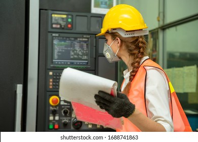 Female Mechanic wearing protective mask to Protect Against Covid-19,Female technician worker working and checking machine in a large industrial factory,Coronavirus Disease 2019 (COVID-19) concept. - Powered by Shutterstock