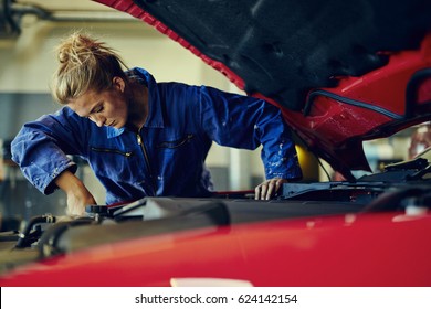 Female Mechanic Working On Car