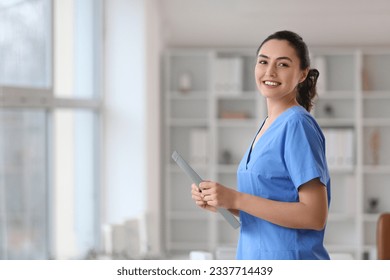 Female medical assistant with clipboard in clinic - Powered by Shutterstock