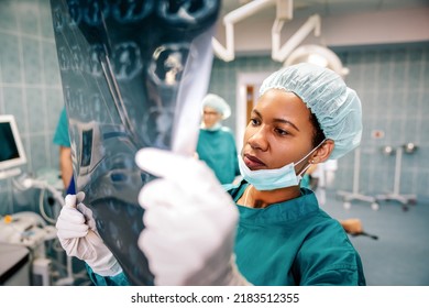 Female medical doctor looking at x-rays in a hospital. Healthcare surgery diagnosis concept