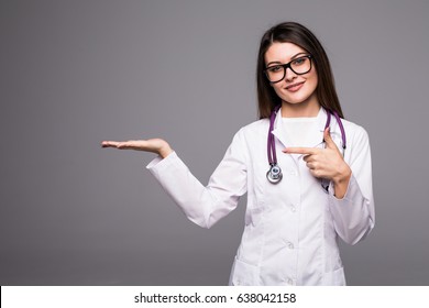 Female medical doctor showing copy space. Woman in white professional uniform with stethoscope on neck invite people to clinic hospital. - Powered by Shutterstock