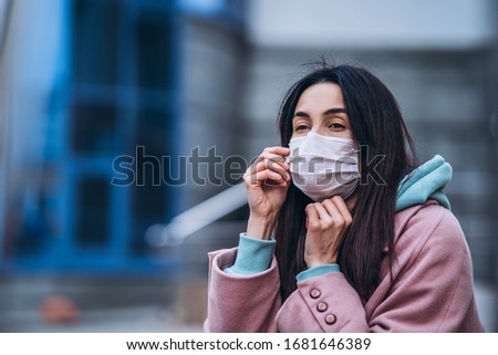 Female in medical mask outdoors in the empty city. Health protection and prevention of virus outbreak, coronavirus, COVID-19, epidemic, pandemic, infectious diseases, quarantine concept