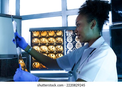 Female Medical Radiologist Doctor Looking Head And Brain X-ray Film Before Surgery In Lab Office At Hospital. Healthcare And Education.