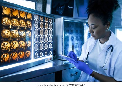 Female Medical Radiologist Doctor Looking Head And Brain X-ray Film Before Surgery In Lab Office At Hospital. Healthcare And Education.