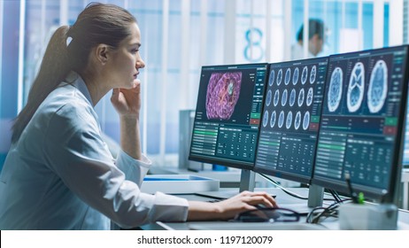 Female Medical Research Scientist Working With Brain Scans On Her Personal Computer. Modern Laboratory Working On Neurophysiology, Science,  Neuropharmacology. Understanding Human Brain.