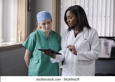 Female Medical Team Consulting With Ipad/tablet