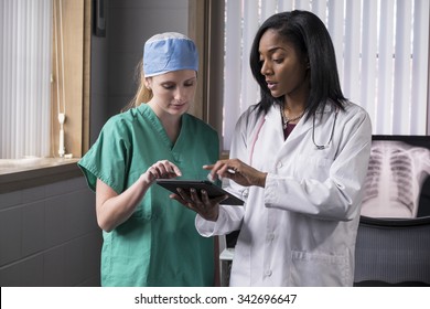 Female medical team consulting with ipad/tablet