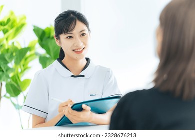 Female medical worker interviewing a patient in medical facility. Nursing. Therapist. - Powered by Shutterstock