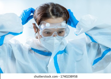 female medical worker wear protective goggles and ready to take care of coronavirus patient in isolation room - Powered by Shutterstock