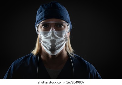 Female Medical Worker Wearing Protective Face Mask and Gear Against Dark Background. - Shutterstock ID 1672849837