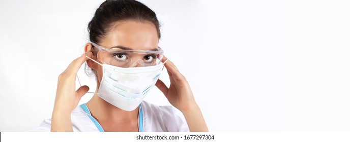 Female Medical Worker Wearing Protective Face Mask, goggles and Gear isolated on white Background. woman Doctor or Nurse Wearing Scrubs, Protective Face Mask and transparent Goggles.