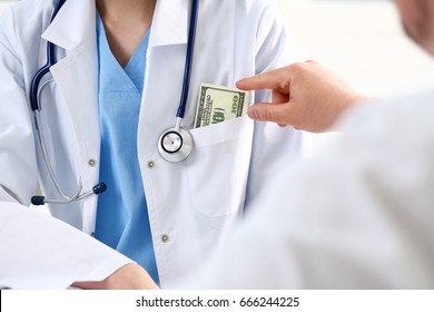 Female Medicine Doctor Chest With Bunch Of Hundred Dollars Banknotes In Pocket. Prestige And High Paid Job, Encash Treatment, Illegal Drug Fraud, Anonymous Visitor, Private Visit, Reform Concept