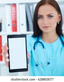 Female medicine doctor  showing  blank screen of smartp hone to camera. Medical equipment, modern technology and communication concept. Theraist using smartphone searching information.