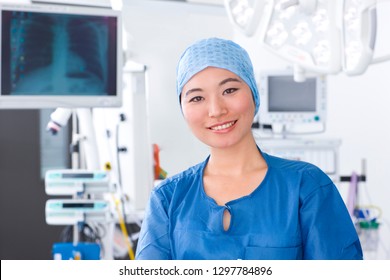 Female Member Of Surgical Team In Hospital Operating Room Smiling At Camera