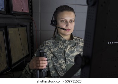 Female Military Drone Operator Working At Computer