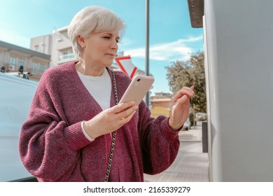 Female With The Mobile Phone At The Petrol Station