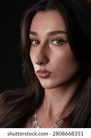 Female model looking at camera with elegant makeup and sparkling necklace