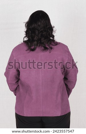 female model posing in purple leather jacket and black top 