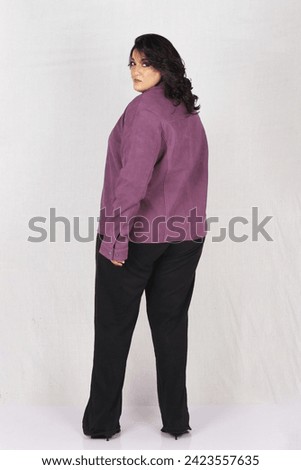 female model posing in purple leather jacket and black top 