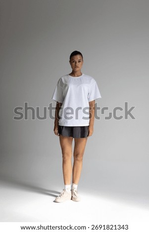female model in studio pose, fulllength female model displaying activewear confidently in studio