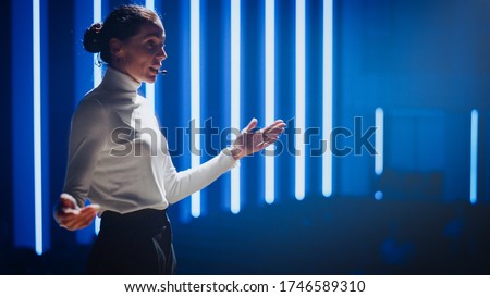 Female Motivational Speaker on Stage, Talking about Happiness, Diversity, Success, Leadership, STEM and How to Be Productive. Woman Presenter Leads Tech Business Conference. Low Angle Portrait