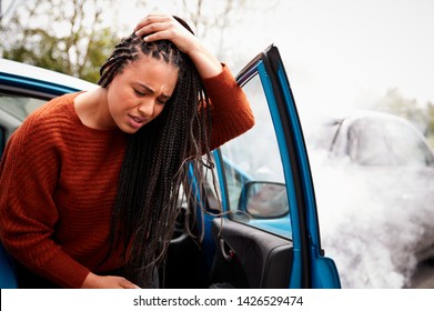 Female Motorist With Head Injury Getting Out Of Car After Crash