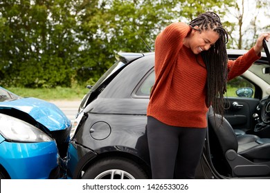 Female Motorist With Whiplash Injury In Car Crash Getting Out Of Vehicle - Shutterstock ID 1426533026