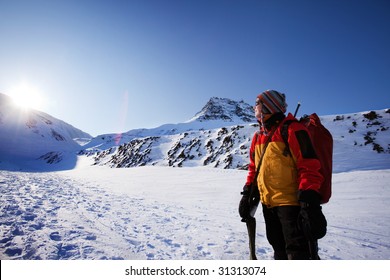 A Female Mountaineer Against A Winter Mountain Landscape