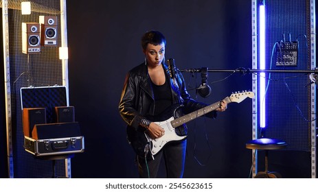 Female musician plays an electric guitar and singing on microphone, delivering a melodic and bold live performance. Vocalist singer with grunge energy and edgy attitude. Camera B. - Powered by Shutterstock