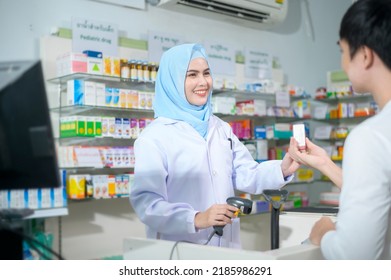 A Female muslim pharmacist counseling customer about drugs usage in a modern pharmacy drugstore. - Powered by Shutterstock