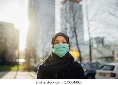 Female Muslim With Protective Surgical Mask.Hijab Woman Wearing Mask In The City.Coronavirus COVID-19 Pandemic Lifestyle In Islamic Country Culture.Spiritual Praying Concerned Person.Faith Challenge