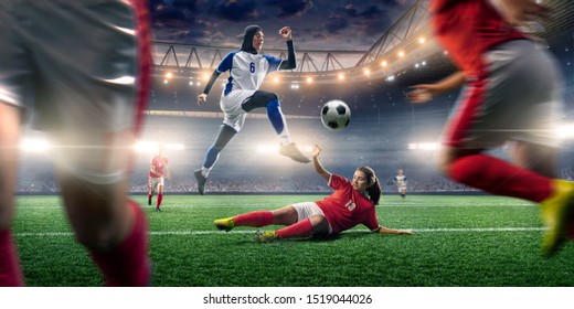 Female muslim soccer player in hijab shows exciting play during the tense moment of the game on a professional soccer stadium. - Powered by Shutterstock