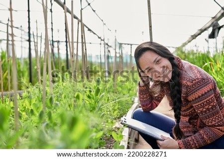 Female  native american research assistant on the field in a greenhouse