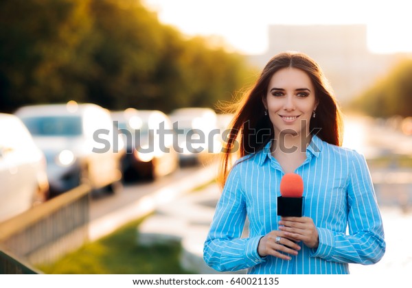 Female News Reporter on Field in Traffic - Woman journalist on the job as a live correspondent 
