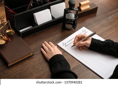 Female notary public working at table