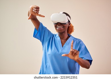 Female Nurse Or Doctor In Scrubs With VR Headset Interacting With AR Technology