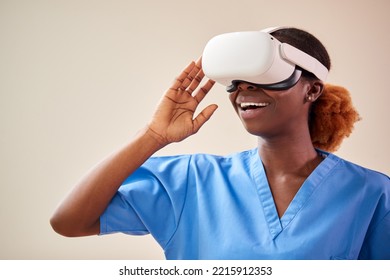 Female Nurse Or Doctor In Scrubs With VR Headset Interacting With AR Technology