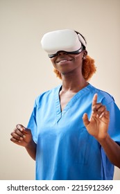 Female Nurse Or Doctor In Scrubs With VR Headset Interacting With AR Technology