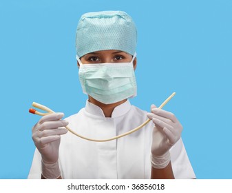 Female nurse holding an urinary catheter isolated against a blue background.