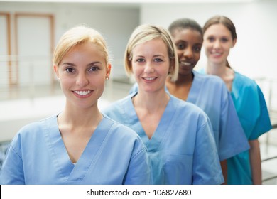 Female Nurse Looking At Camera In Hospital Hallway